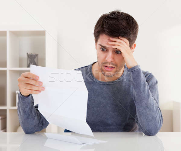 Horrified man reading a document Stock photo © AndreyPopov