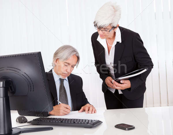The boss signing a document Stock photo © AndreyPopov