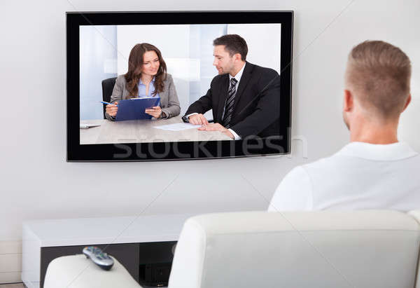 Stock photo: Man sitting watching television at home