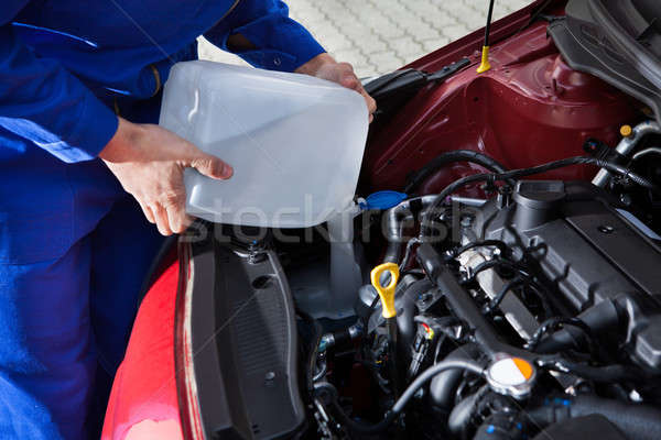 Mechanic Pouring Antifreeze Into Windscreen Water Tank Stock photo © AndreyPopov