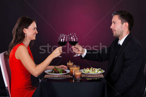 Stock photo: Couple Tossing Wine Glass