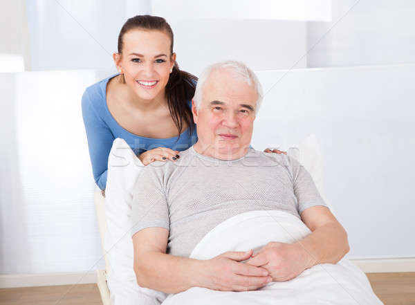 Portrait Of Happy Caregiver With Senior Man Stock photo © AndreyPopov
