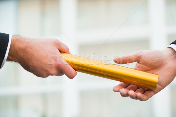 Businessman Giving Relay Baton To Colleague Stock photo © AndreyPopov