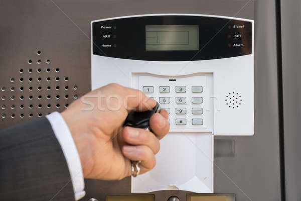 Businessperson Hand Operating Security System Stock photo © AndreyPopov