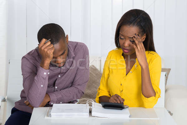 Triste casal olhando projeto de lei jovem africano Foto stock © AndreyPopov