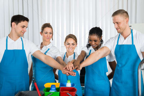 Happy Cleaners Stacking Hands Stock photo © AndreyPopov