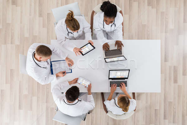 Doctors With Laptop And Digital Tablet In Meeting Stock photo © AndreyPopov