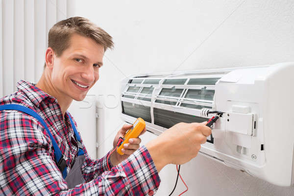 Technician Examining Air Conditioner Stock photo © AndreyPopov