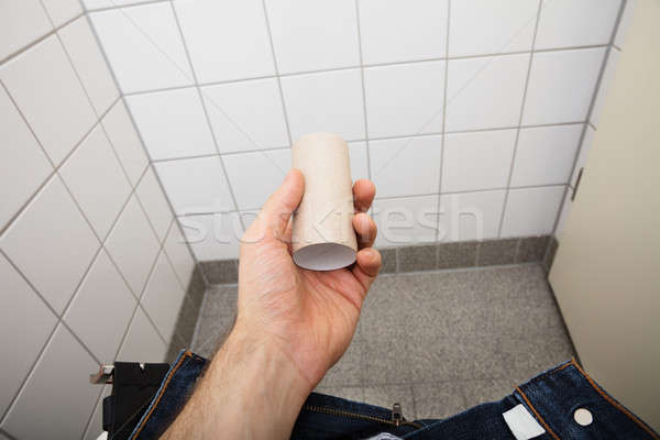 Hand Holding Empty Toilet Paper Roll Stock photo © AndreyPopov