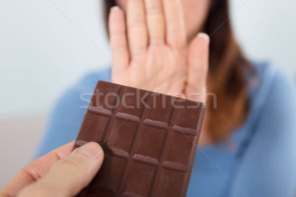Woman Rejecting Chocolate Bar Stock photo © AndreyPopov