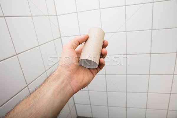 Kéz tart üres vécépapír zsemle közelkép Stock fotó © AndreyPopov