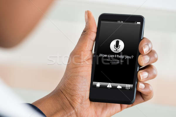 Man Holding Mobile Phone With How Can I Help You? Stock photo © AndreyPopov