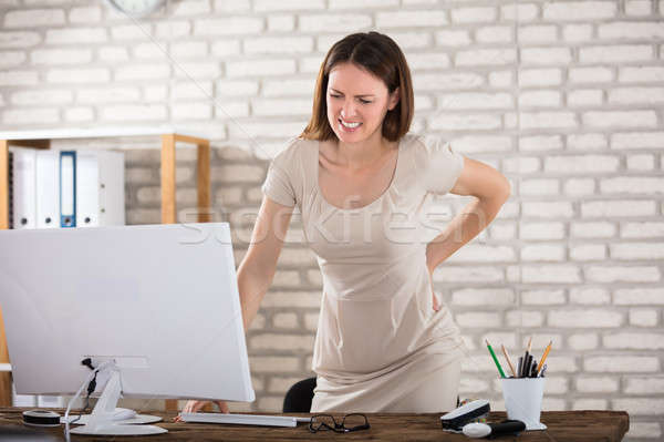 Businesswoman Suffering From Back Pain Stock photo © AndreyPopov