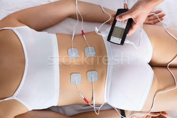 Woman Lying With Electrodes On Her Back Stock photo © AndreyPopov
