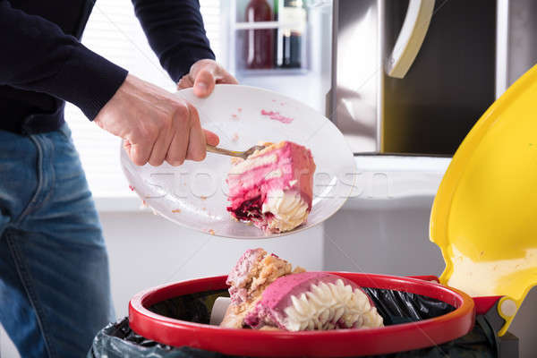 Person Throwing Cake In Trash Bin Stock photo © AndreyPopov