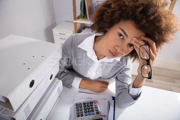 Tired Businesswoman Sitting In Office With Stack Of Files Stock photo © AndreyPopov
