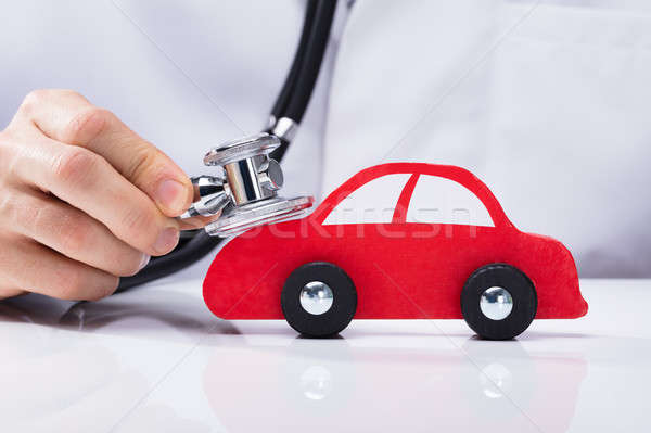 Doctor Examining Car With Stethoscope Stock photo © AndreyPopov