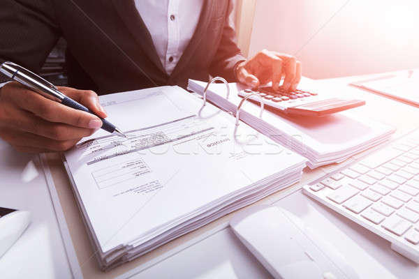 Close-up Of A Businessperson Calculating Bill Stock photo © AndreyPopov