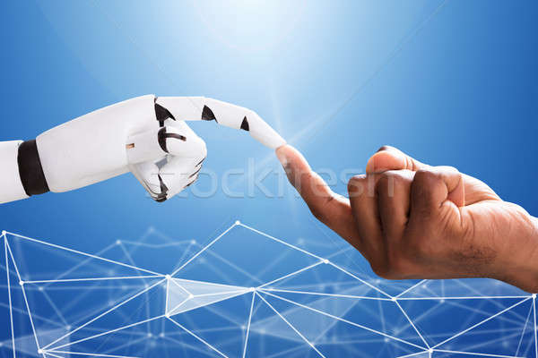 Stock photo: Robot Touching Man's Index Finger