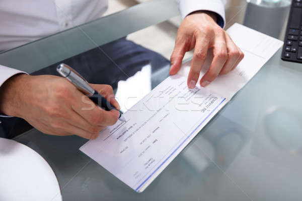 Businessman Signing Cheque Stock photo © AndreyPopov