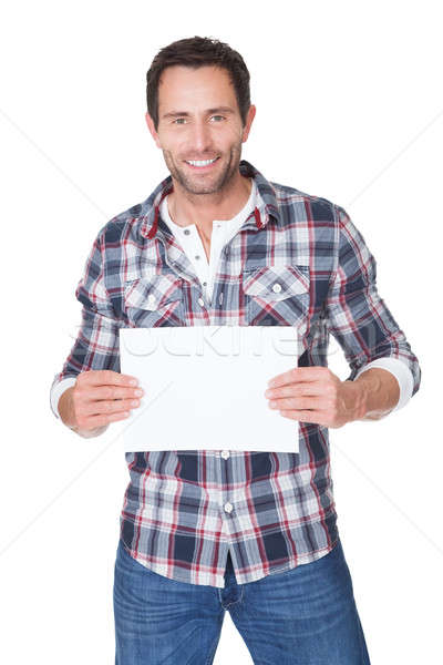 Happy middle age man presenting empty paper Stock photo © AndreyPopov