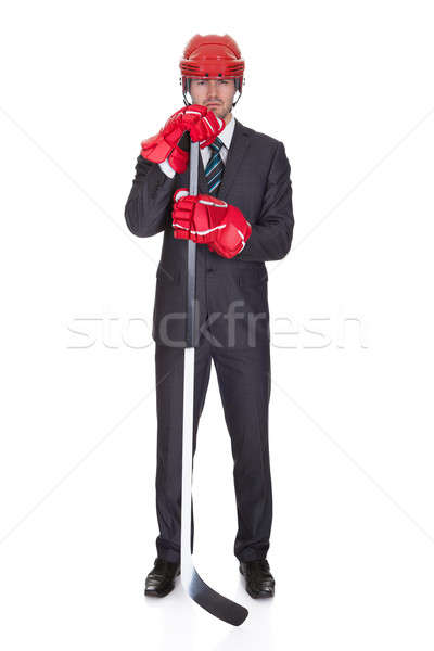 Competitive businessman wearing hockey equipment Stock photo © AndreyPopov