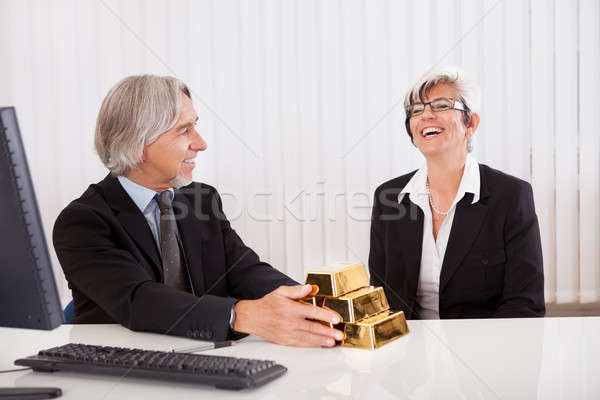 Businesswoman with gold bullion bars Stock photo © AndreyPopov