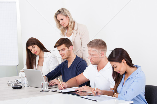 Businesspeople Studying At Desk Stock photo © AndreyPopov