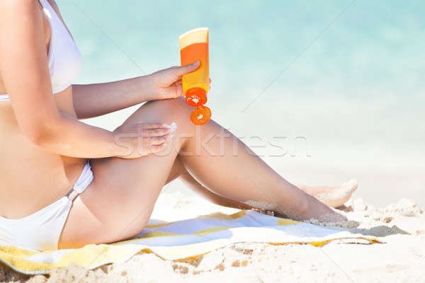 Nő bikini jelentkezik napozókrém oldalnézet ül Stock fotó © AndreyPopov
