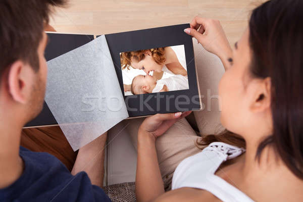 Couple Looking Through Photo Album Stock photo © AndreyPopov