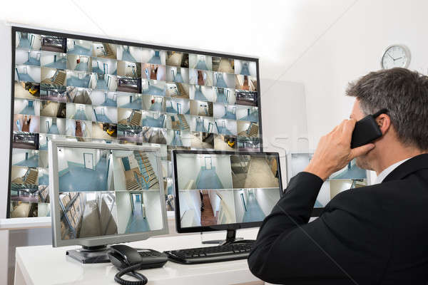 Security System Operator Looking At Cctv Footage Stock photo © AndreyPopov