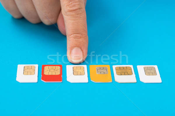 Stock photo: Person Hand Selecting Sim Card