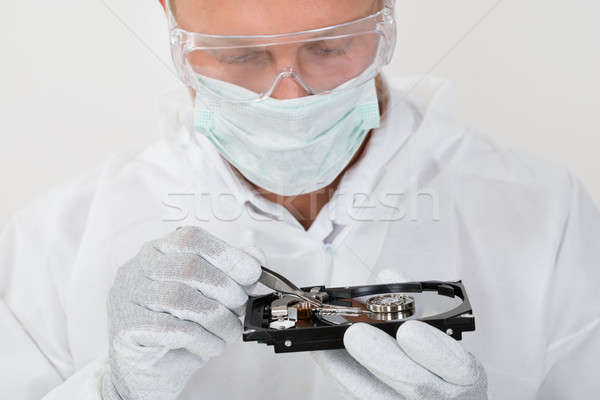 Man Repairing Harddisk With Tweezers Stock photo © AndreyPopov