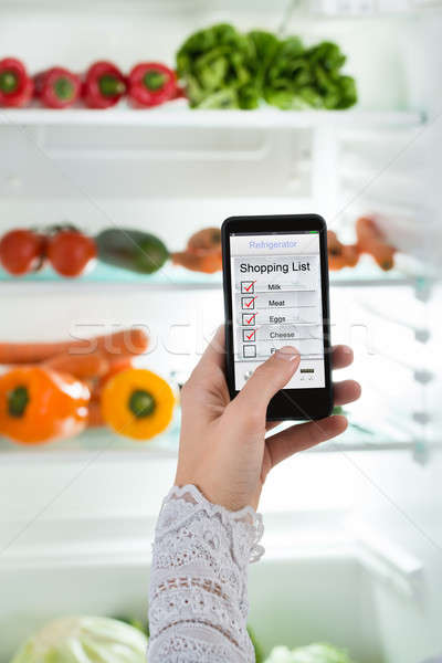 Person Hand With Mobile Phone Showing Shopping List Stock photo © AndreyPopov