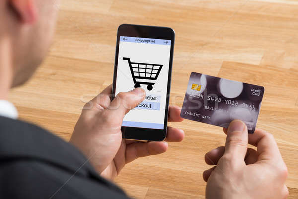 Businessman With Mobile Phone And Credit Card Stock photo © AndreyPopov