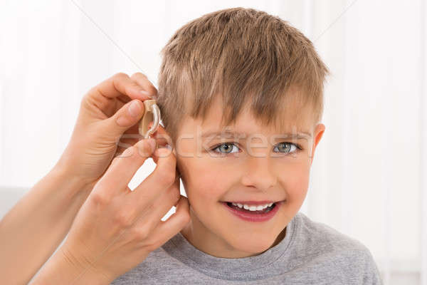 Close-up Of A Smiling Boy With Hearing Aid Stock photo © AndreyPopov