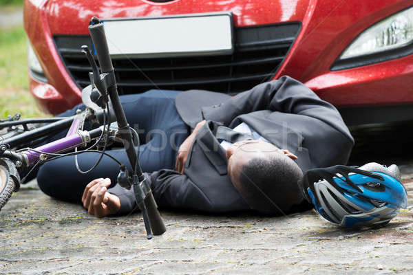 Cyclist Lying On Street After Accident Stock photo © AndreyPopov