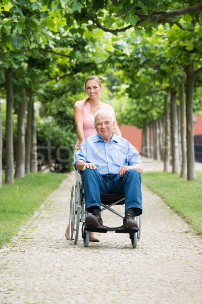 Woman With Her Old Senior Father On Wheelchair Stock photo © AndreyPopov