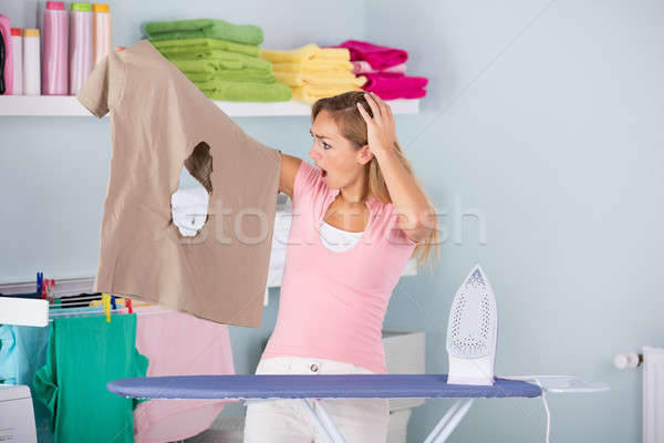 Shocked Woman Looking At Burned Iron Cloth Stock photo © AndreyPopov