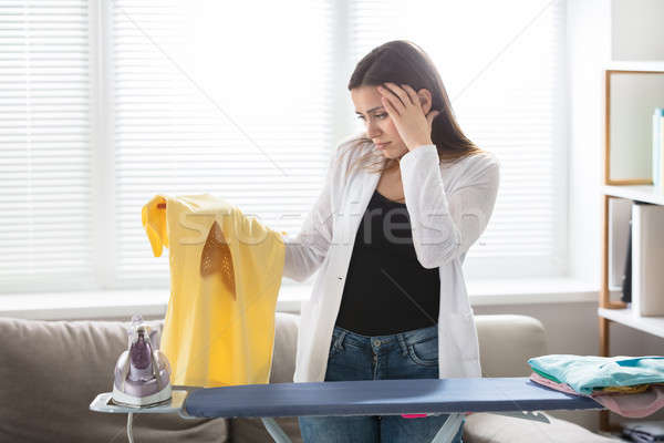 Preocupado mujer camiseta hierro Foto stock © AndreyPopov