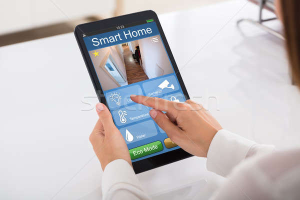 Person Using Smart Home System On Digital Tablet Stock photo © AndreyPopov