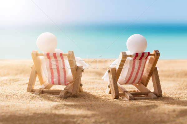 Two Human Figures Relaxing On Deck Chairs Stock photo © AndreyPopov