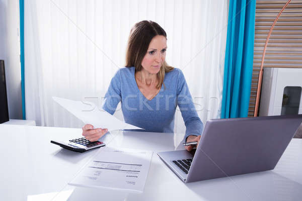 Woman Calculating Invoice With Calculator At Home Stock photo © AndreyPopov