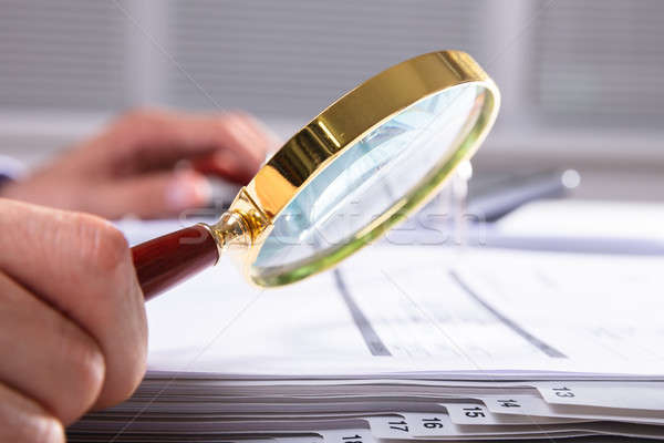 Stock photo: Businessperson Checking Invoice Through Magnifying Glass