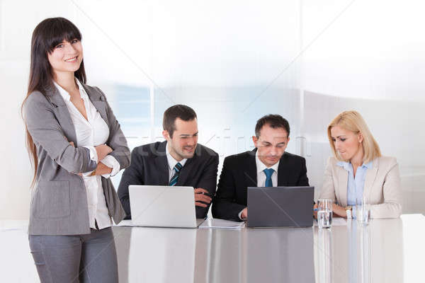 Woman Standing In front Of Colleges Working In Office Stock photo © AndreyPopov