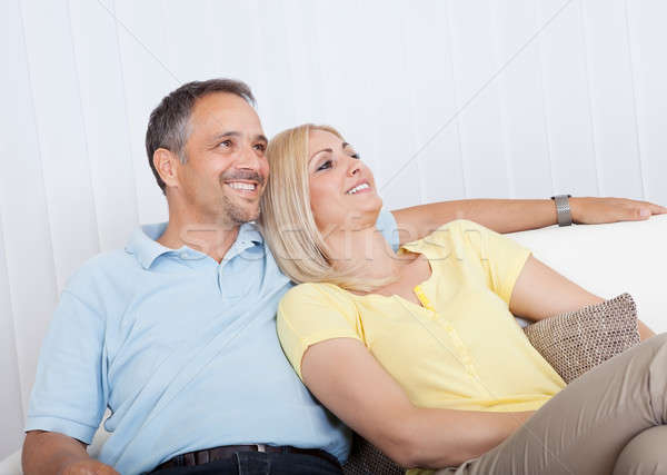Loving couple relaxing on a sofa Stock photo © AndreyPopov