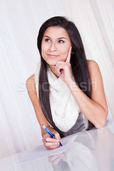 Woman sitting writing notes Stock photo © AndreyPopov