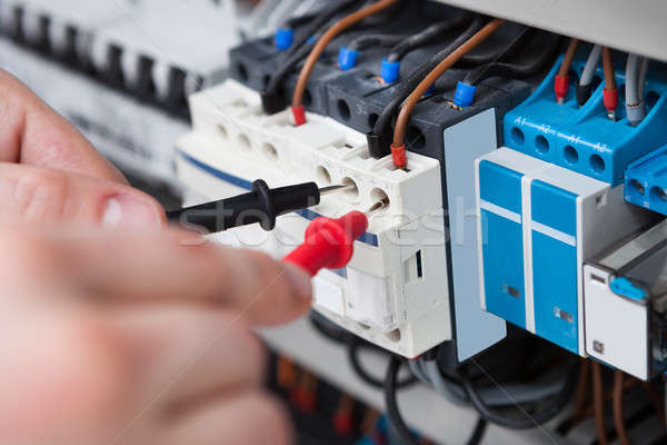 Electrician Examining Fusebox With Multimeter Probe Stock photo © AndreyPopov