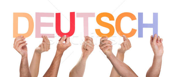 Stock photo: Close-up Of Hands Holding Text Deutsch