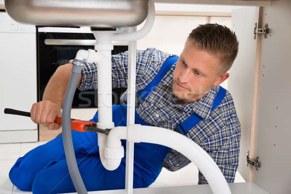 Plumber Fixing White Sink Pipe Stock photo © AndreyPopov